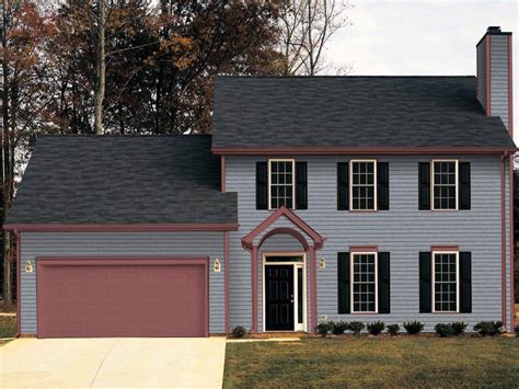 red metal roof on grey house|grey house with black awnings.